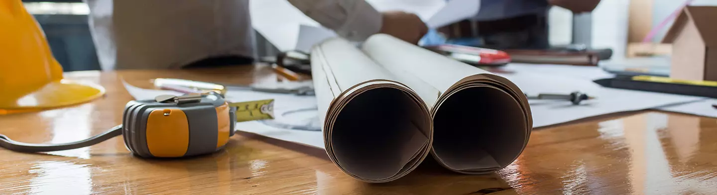 Architect working on blueprint in the office.